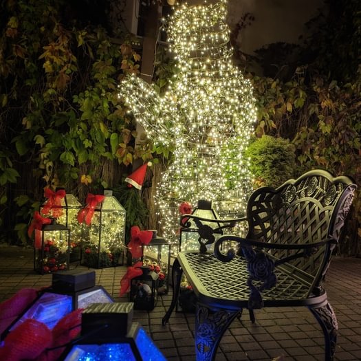 Decorated Old Town courtyard with bear sculptures and a glowing tree